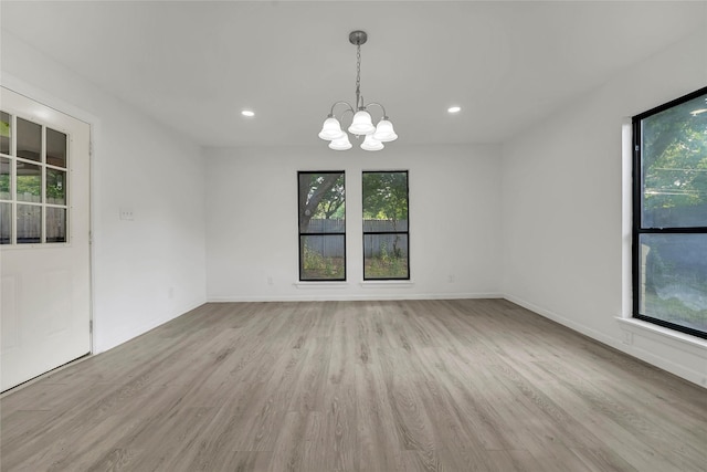 6825 John Dr, Richland Hills, TX 76118 - spare room featuring healthy amount of natural light, a chandelier, light wood-type flooring, and recessed lighting