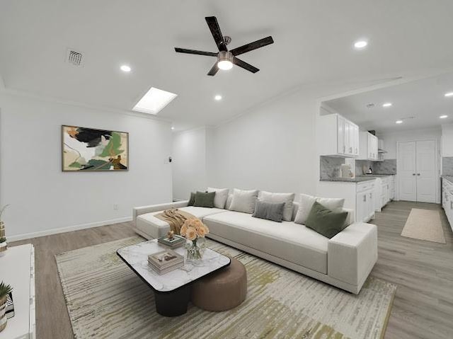 6825 John Dr, Richland Hills, TX 76118 - living area featuring a ceiling fan, recessed lighting, light wood-type flooring, a skylight, and lofted ceiling