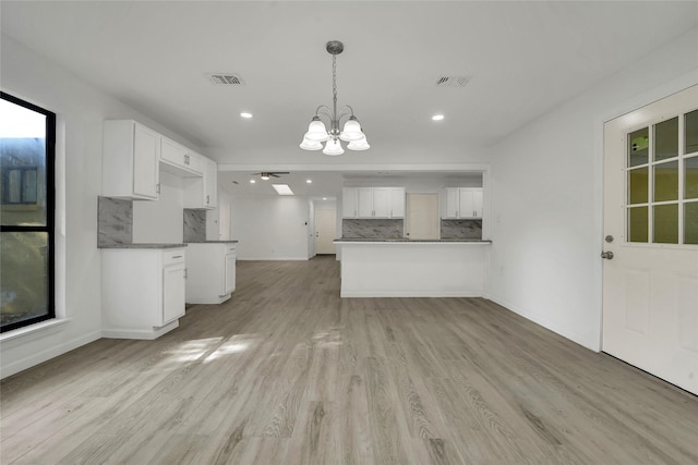 6825 John Dr, Richland Hills, TX 76118 - kitchen featuring a chandelier, backsplash, light wood-type flooring, white cabinetry, and recessed lighting