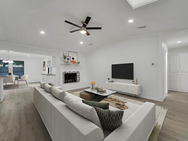 6825 John Dr, Richland Hills, TX 76118 - living area featuring wood finished floors, vaulted ceiling, recessed lighting, a ceiling fan, and baseboards