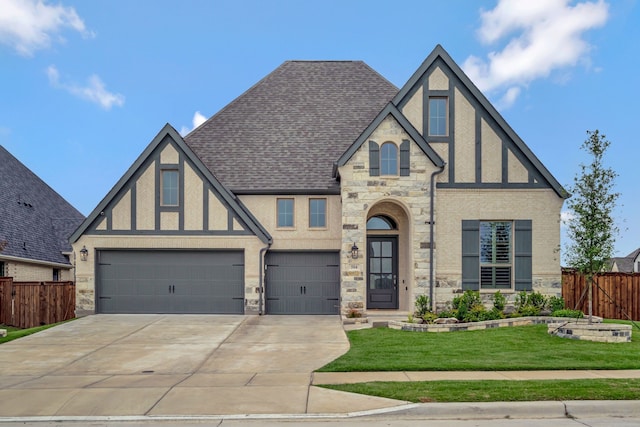 504 Arrowhead Ln, Haslet, TX 76052 - tudor-style house featuring stone siding, stucco siding, concrete driveway, and a shingled roof
