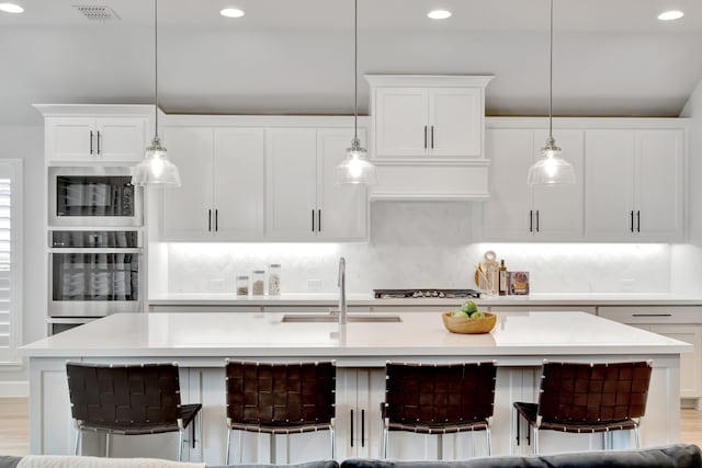 504 Arrowhead Ln, Haslet, TX 76052 - kitchen featuring oven, built in microwave, backsplash, light countertops, and recessed lighting