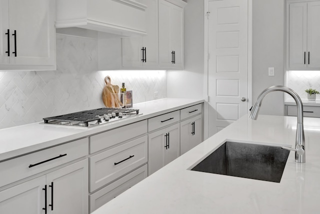 504 Arrowhead Ln, Haslet, TX 76052 - kitchen with stainless steel gas stovetop, light countertops, white cabinets, and tasteful backsplash