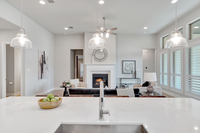 504 Arrowhead Ln, Haslet, TX 76052 - kitchen with a lit fireplace, recessed lighting, ceiling fan, open floor plan, and decorative light fixtures