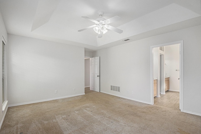 2109 Timber Cove Ct, Weatherford, TX 76087 - unfurnished bedroom with carpet flooring, a tray ceiling, baseboards, ensuite bathroom, and ceiling fan