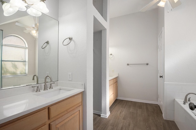 2109 Timber Cove Ct, Weatherford, TX 76087 - full bath featuring ceiling fan, vanity, wood finished floors, a garden tub, and vaulted ceiling