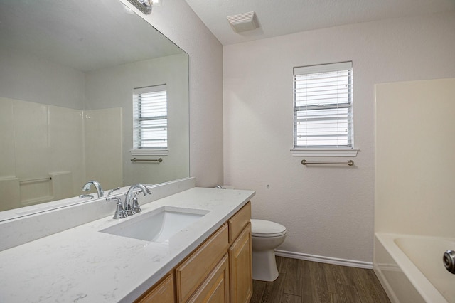 2109 Timber Cove Ct, Weatherford, TX 76087 - full bath with wood finished floors, vanity, toilet, baseboards, and shower / tub combination