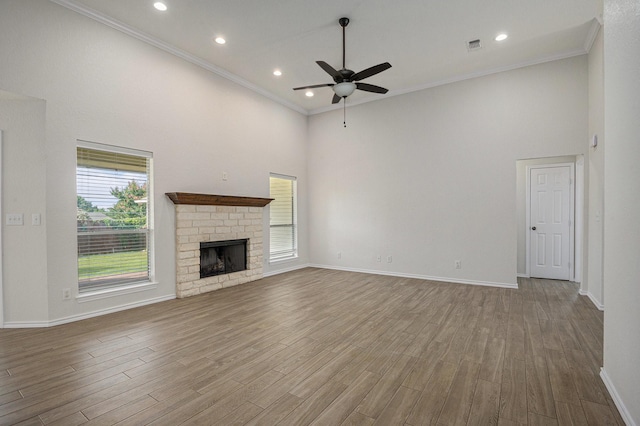2109 Timber Cove Ct, Weatherford, TX 76087 - unfurnished living room with a high ceiling, ceiling fan, baseboards, wood finished floors, and crown molding