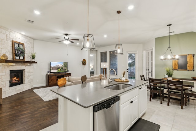10113 Warberry Trl, Fort Worth, TX 76131 - kitchen featuring dishwasher, a sink, open floor plan, a center island with sink, and a fireplace