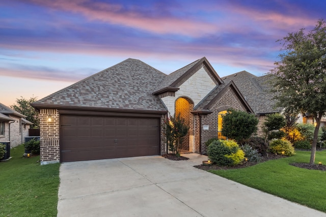 10113 Warberry Trl, Fort Worth, TX 76131 - french country home with driveway, a front yard, a garage, and brick siding