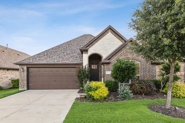 10113 Warberry Trl, Fort Worth, TX 76131 - french country home featuring a garage, brick siding, driveway, and a shingled roof
