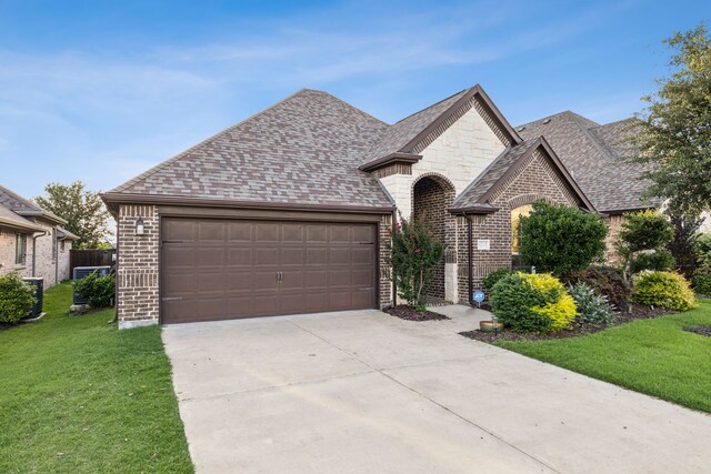 10113 Warberry Trl, Fort Worth, TX 76131 - french country inspired facade with brick siding, a front yard, driveway, and an attached garage