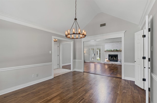 213 Redwood Ct, Keller, TX 76248 - unfurnished living room with a chandelier, vaulted ceiling, dark wood-style flooring, and a fireplace