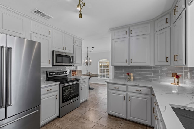 213 Redwood Ct, Keller, TX 76248 - kitchen featuring stainless steel appliances, backsplash, tile patterned floors, white cabinetry, and light stone counters