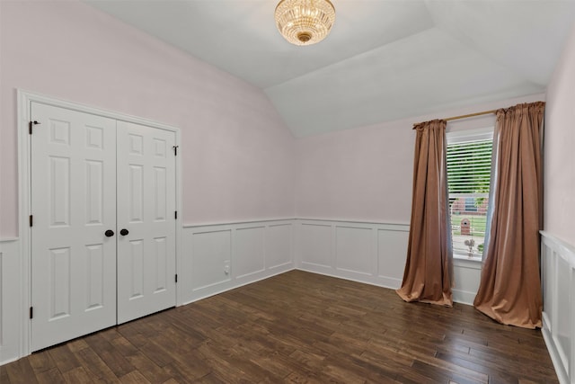 213 Redwood Ct, Keller, TX 76248 - unfurnished bedroom featuring lofted ceiling, dark wood-style floors, wainscoting, and a decorative wall