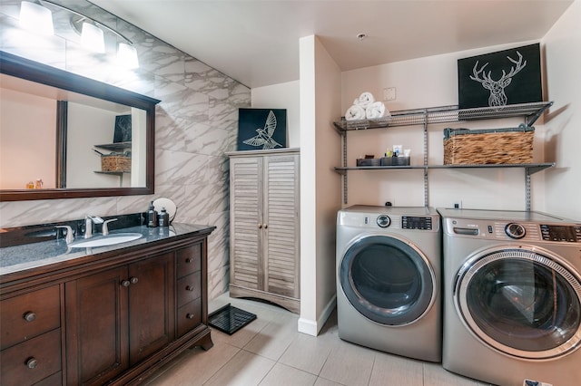 1122 Jackson St Unit 220, Dallas, TX 75202 - washroom featuring light tile patterned flooring, washer and clothes dryer, and tile walls