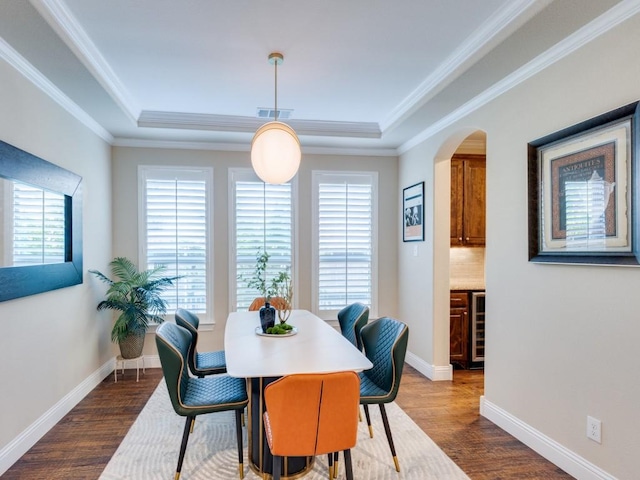 2040 Grassland Dr, Allen, TX 75013 - dining space with arched walkways, dark wood-style flooring, a tray ceiling, crown molding, and baseboards