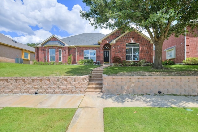 2772 Summertree Dr, Carrollton, TX 75006 - view of front of home with brick siding, central AC unit, and a front yard