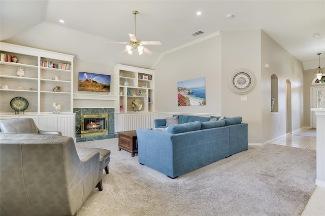2772 Summertree Dr, Carrollton, TX 75006 - living area featuring lofted ceiling, light colored carpet, ceiling fan, arched walkways, and a premium fireplace