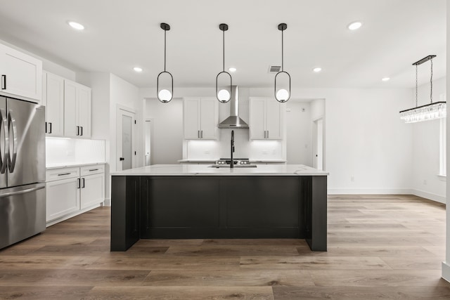 605 Utopia Rd, Tool, TX 75143 - kitchen featuring freestanding refrigerator, wall chimney range hood, recessed lighting, white cabinetry, and light countertops