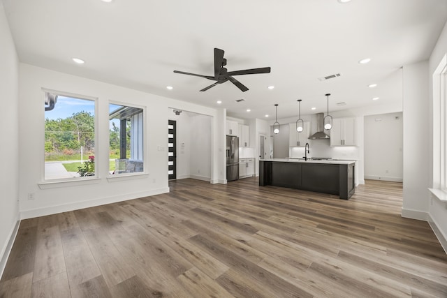 605 Utopia Rd, Tool, TX 75143 - unfurnished living room featuring a ceiling fan, a sink, wood finished floors, baseboards, and recessed lighting
