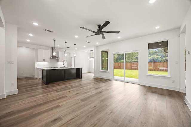 605 Utopia Rd, Tool, TX 75143 - unfurnished living room with a sink, ceiling fan, recessed lighting, light wood-type flooring, and baseboards