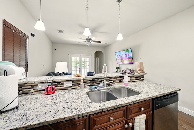 2901 18th St, Fort Worth, TX 76106 - kitchen featuring dishwasher, a sink, arched walkways, dark wood finished floors, and tasteful backsplash