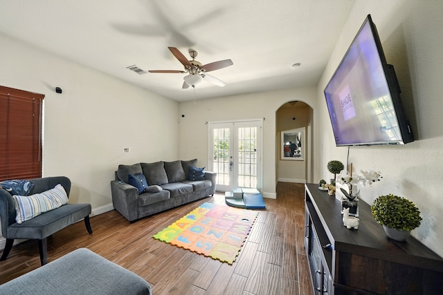 2901 18th St, Fort Worth, TX 76106 - living area featuring arched walkways, a ceiling fan, wood finished floors, and french doors