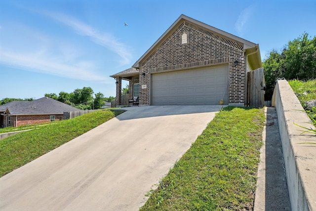 2901 18th St, Fort Worth, TX 76106 - view of front of home featuring brick siding, a garage, and concrete driveway