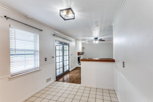 9139 Bretshire Dr, Dallas, TX 75228 - interior space featuring french doors, ceiling fan, ornamental molding, a wainscoted wall, and light tile patterned floors