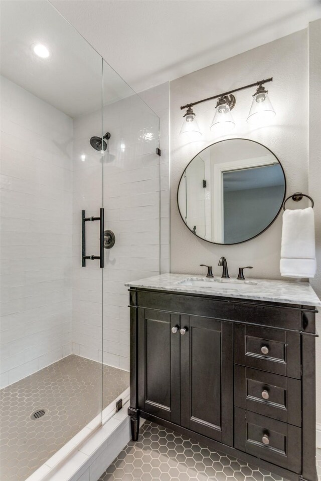 9139 Bretshire Dr, Dallas, TX 75228 - bathroom with a stall shower, tile patterned flooring, vanity, and recessed lighting