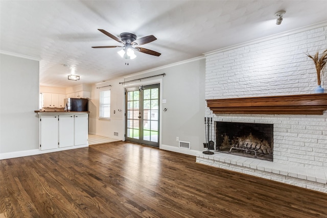 9139 Bretshire Dr, Dallas, TX 75228 - unfurnished living room featuring wood finished floors, a ceiling fan, baseboards, a fireplace, and crown molding