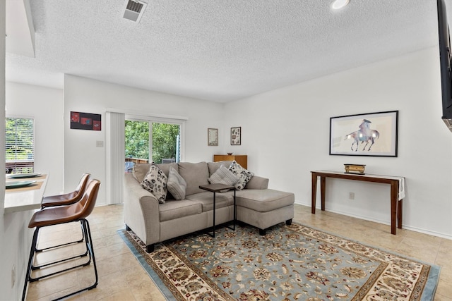 2506 Wedglea Dr Unit 907, Dallas, TX 75211 - living area with a textured ceiling and light tile patterned floors