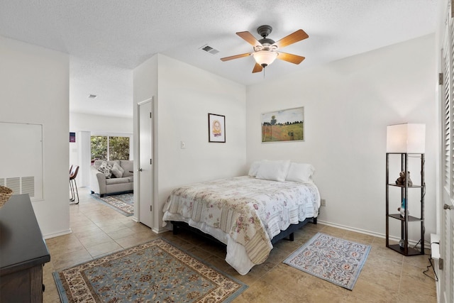 2506 Wedglea Dr Unit 907, Dallas, TX 75211 - tiled bedroom with a textured ceiling, ceiling fan, and baseboards