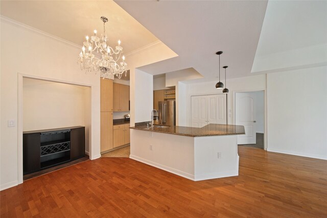 3225 Turtle Creek Blvd Unit 320, Dallas, TX 75219 - kitchen featuring high end fridge, a sink, wood finished floors, dark stone countertops, and ornamental molding