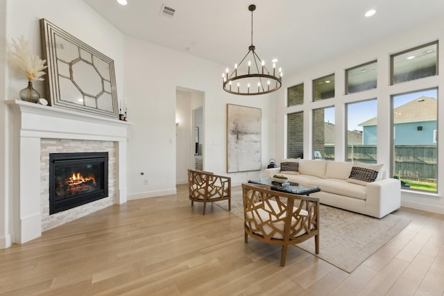 2241 Robin Way, Northlake, TX 76247 - living area with light wood-style floors, a chandelier, recessed lighting, a stone fireplace, and baseboards
