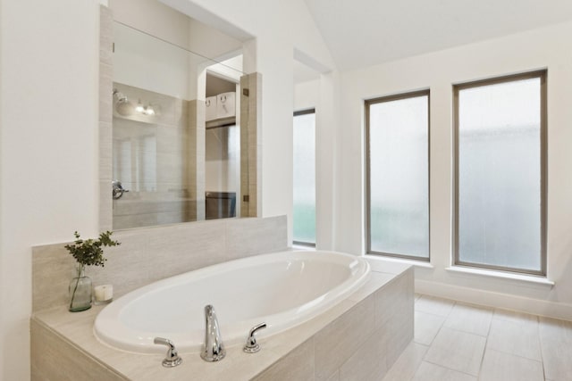 2241 Robin Way, Northlake, TX 76247 - bathroom featuring a garden tub, vaulted ceiling, and tile patterned flooring