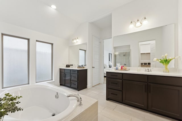 2241 Robin Way, Northlake, TX 76247 - full bath featuring vaulted ceiling, a bath, two vanities, and walk in shower