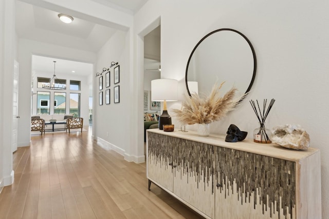 2241 Robin Way, Northlake, TX 76247 - hall featuring a chandelier, baseboards, and light wood-style floors