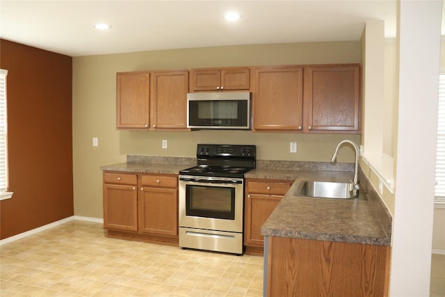 12645 Foxpaw Trl, Fort Worth, TX 76244 - kitchen featuring appliances with stainless steel finishes, a sink, recessed lighting, dark countertops, and baseboards