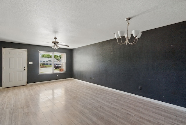5608 Humbert Ave, Fort Worth, TX 76107 - unfurnished room with ceiling fan, wood finished floors, a chandelier, a textured ceiling, and baseboards