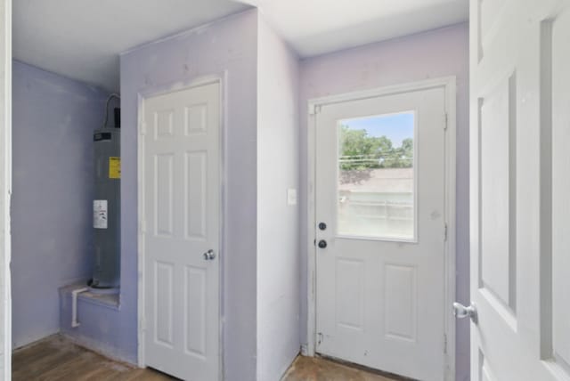 5608 Humbert Ave, Fort Worth, TX 76107 - doorway to outside featuring electric water heater and wood finished floors