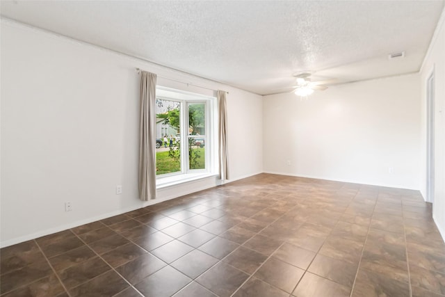 1619 Marquette Dr, Richardson, TX 75081 - spare room with a ceiling fan, a textured ceiling, dark tile patterned floors, and baseboards