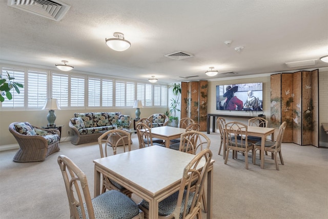 6335 W NW Hwy Unit 1314, Dallas, TX 75225 - dining area with light carpet and a textured ceiling