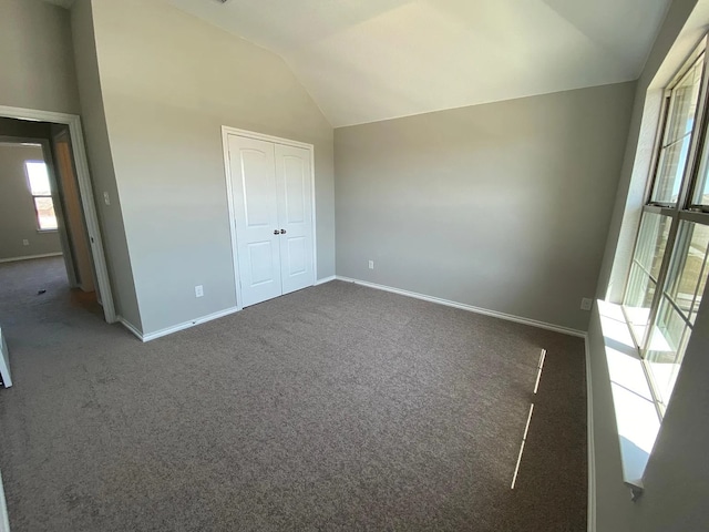 523 Long Pr, Royse City, TX 75189 - unfurnished bedroom with lofted ceiling, baseboards, carpet flooring, and a closet
