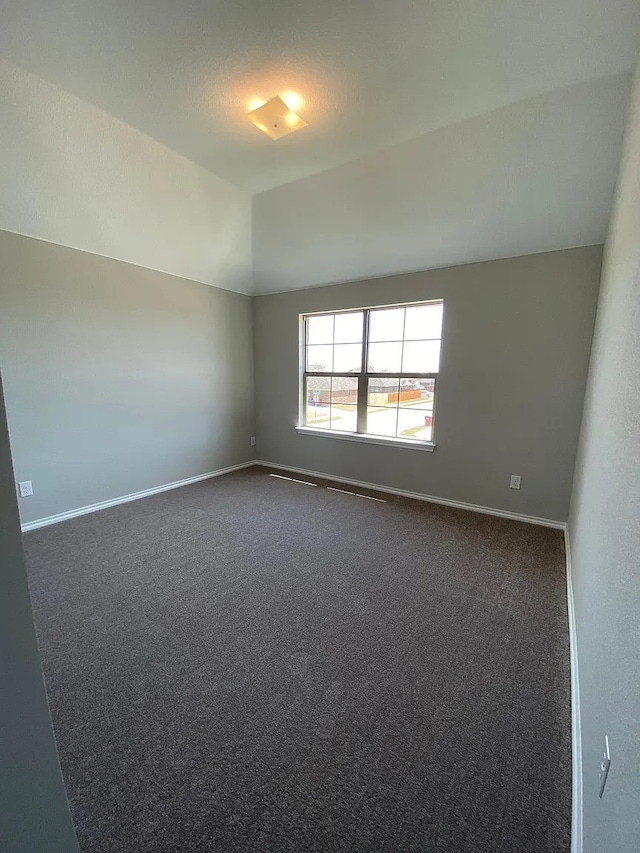 523 Long Pr, Royse City, TX 75189 - unfurnished room featuring dark colored carpet, baseboards, and vaulted ceiling