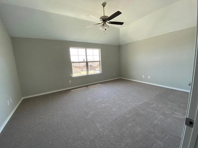 523 Long Pr, Royse City, TX 75189 - unfurnished room with a ceiling fan, dark carpet, baseboards, and vaulted ceiling