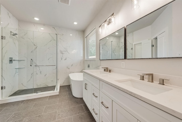 137 Willow Ln, Roanoke, TX 76262 - bathroom featuring a marble finish shower, double vanity, a soaking tub, and recessed lighting