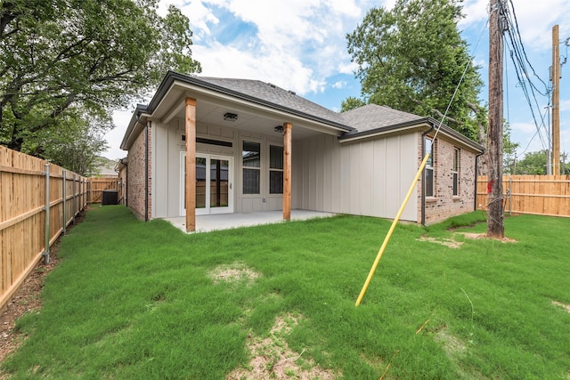 137 Willow Ln, Roanoke, TX 76262 - back of property with brick siding, a shingled roof, central AC, a patio, and board and batten siding