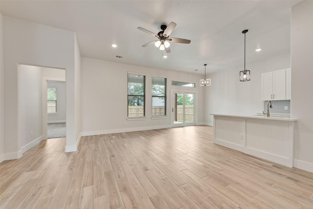 137 Willow Ln, Roanoke, TX 76262 - unfurnished living room with light wood finished floors, a ceiling fan, healthy amount of natural light, baseboards, and recessed lighting